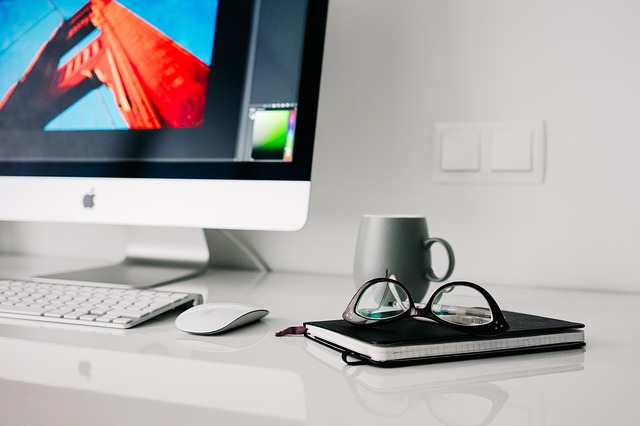 Desktop computer and notebook used for planning and documentation
