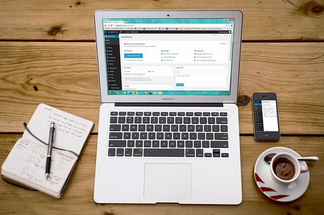 Laptop and smartphone arranged in a productive workspace